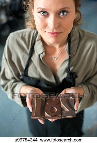 Woman holding traditional letterpress numerals workshop View Large Photo Image Picture - Woman holding traditional letterpress numerals workshop. Fotosearch