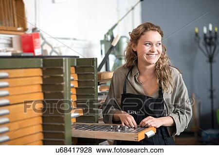 Woman with letterpress tray in print workshop View Large Photo Image Stock Photo - Woman with letterpress tray in print workshop. Fotosearch