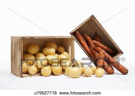 Stock Photo - Wood crates filled with fresh carrots and potatoes. Fotosearch