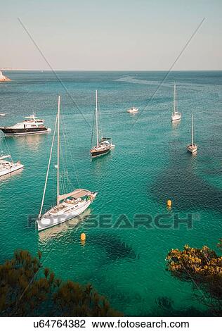 Stock Image - Yachts anchored in bay at Cala Macarella, Menorca, Spain. Fotosearch