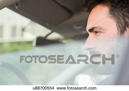 Young businessman looking from car window View Large Photo Image Picture - Young businessman looking from car window. Fotosearch