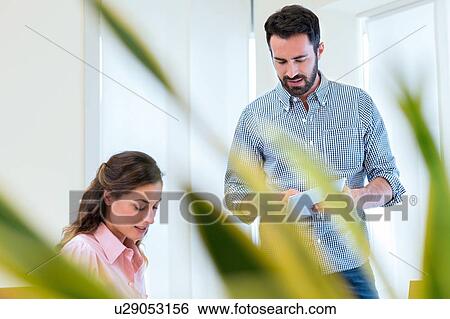 Young businesswoman and man meeting in office View Large Photo Image Stock Photograph - Young businesswoman and man meeting in office. Fotosearch