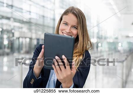 Young businesswoman using digital tablet View Large Photo Image Stock Photography - Young businesswoman using digital tablet. Fotosearch