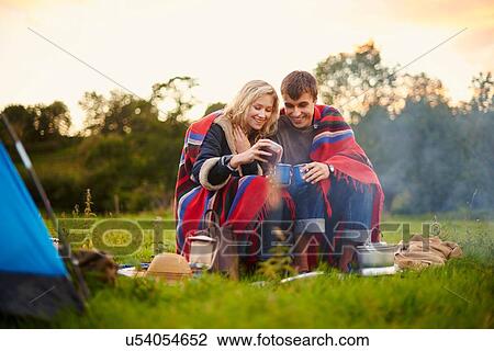Young camping couple drinking tea View Large Photo Image Stock Image - Young camping couple drinking tea. Fotosearch