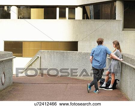 Young couple chatting on walkway, Melbourne, Victoria, Australia View Large Photo Image Stock Photograph - Young couple chatting on walkway, Melbourne, Victoria, Australia. Fotosearch