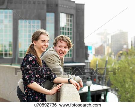 Stock Photograph - Young couple enjoying view from terrace, Melbourne, Victoria, Australia. Fotosearch