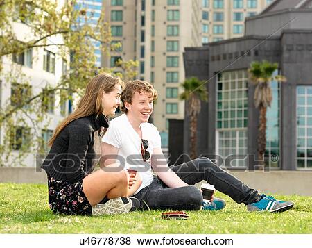 Young couple having coffee break on grass, Melbourne, Victoria, Australia View Large Photo Image Stock Photo - Young couple having coffee break on grass, Melbourne, Victoria, Australia. Fotosearch