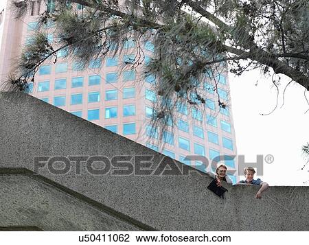Young couple looking down from concrete wall, Melbourne, Victoria, Australia View Large Photo Image Stock Image - Young couple looking down from concrete wall, Melbourne, Victoria, Australia. Fotosearch