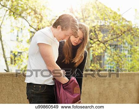 Young couple looking for something in bag, Melbourne, Victoria, Australia View Large Photo Image Stock Photo - Young couple looking for something in bag, Melbourne, Victoria, Australia. Fotosearch