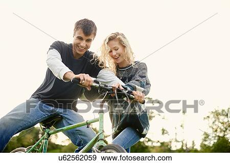 Stock Photo - Young couple with bicycle. Fotosearch