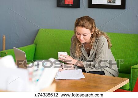 Young female designer working from office sofa View Large Photo Image Stock Image - Young female designer working from office sofa. Fotosearch