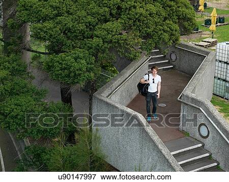 Stock Photo - Young man walking on staircase, Melbourne, Victoria, Australia. Fotosearch