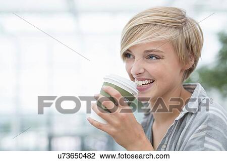 Young woman drinking takeaway coffee in city View Large Photo Image Stock Image - Young woman drinking takeaway coffee in city. Fotosearch