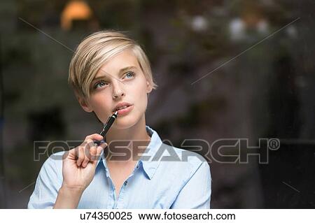 Young woman gazing through window View Large Photo Image Stock Photography - Young woman gazing through window. Fotosearch