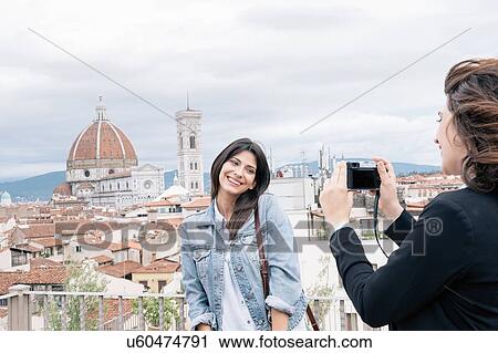 Young woman posing for friend taking photograph in front of Florence Cathedral and Giotto's Campanile looking over shoulder smiling, Florence, Tuscany, Italy View Large Photo Image Stock Image - Young woman posing for friend taking photograph in front of Florence Cathedral and Giotto's Campanile looking over shoulder smiling, Florence, Tuscany, Italy. Fotosearch