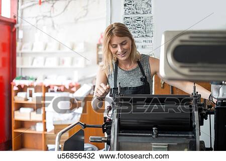 Young woman working on traditional letterpress print machine in workshop View Large Photo Image Stock Image - Young woman working on traditional letterpress print machine in workshop. Fotosearch