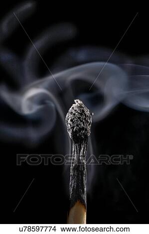 Stock Illustration - Burnt matchstick and smoke against a black background.. Fotosearch