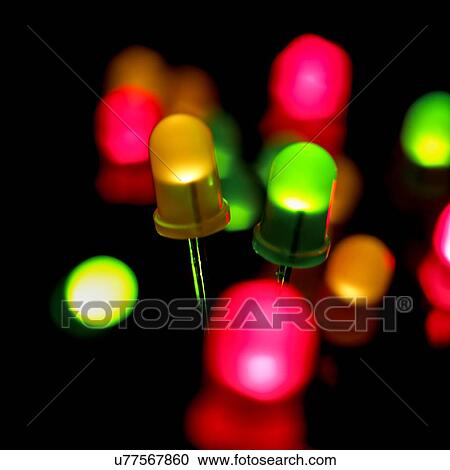 Clipart - Coloured light emitting diodes (LEDs) against a black background.. Fotosearch