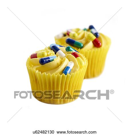 Clipart - Diet pills, conceptual image. Cup cakes with capsules on the top.. Fotosearch