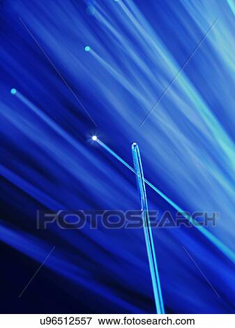 Stock Illustration - Fibre optic being thread through a needle, close up.. Fotosearch