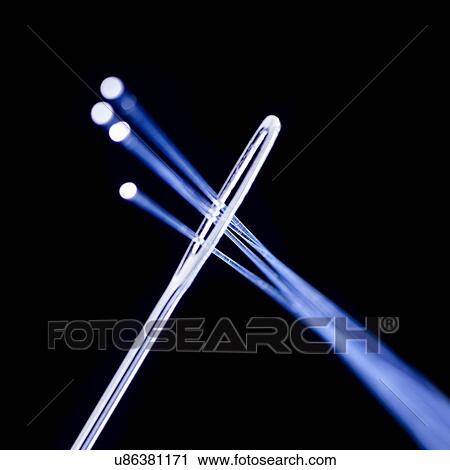 Clip Art - Fibre optics being thread through a needle, close up.. Fotosearch