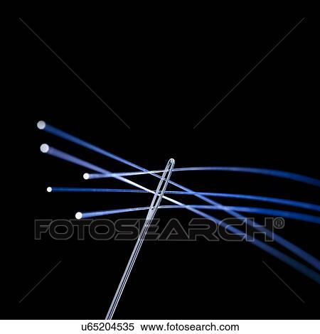 Stock Illustration - Fibre optics being thread through a needle, close up.. Fotosearch
