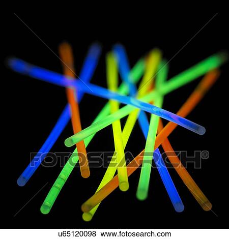 Stock Illustration - Glow sticks against a black background.. Fotosearch
