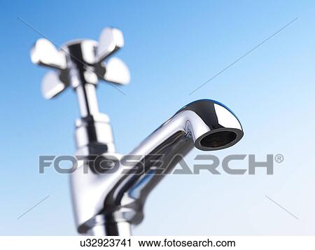 Clip Art - Metal tap against a blue background.. Fotosearch