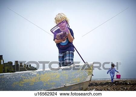 MODEL RELEASED. Boys playing on the beach with fishing net. View Large Photo Image Picture - MODEL RELEASED. Boys playing on the beach with fishing net.. Fotosearch