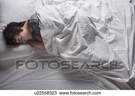MODEL RELEASED. Young man asleep in a bed. View Large Photo Image Stock Image - MODEL RELEASED. Young man asleep in a bed.. Fotosearch