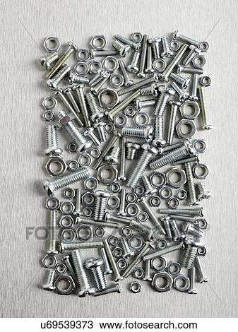 Nuts and bolts against a grey background. View Large Illustration Drawing - Nuts and bolts against a grey background.. Fotosearch