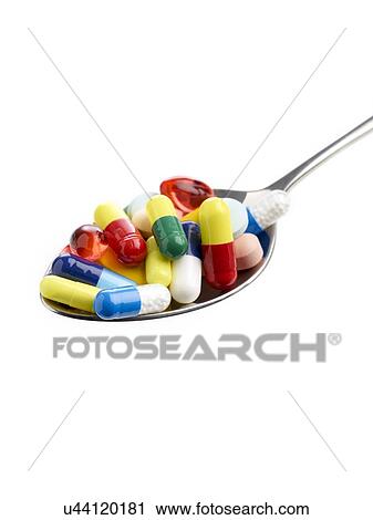 Spoon full of tablets and capsules against a white background. View Large Illustration Clip Art - Spoon full of tablets and capsules against a white background.. Fotosearch
