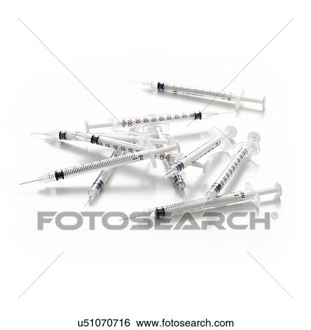 Stock Illustration - Syringes against a white background.. Fotosearch