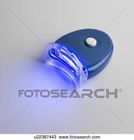 UV (ultraviolet) whitener for teeth against a plain background. View Large Illustration Drawing - UV (ultraviolet) whitener for teeth against a plain background.. Fotosearch