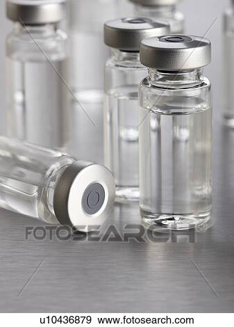 Stock Illustration - Vaccine vials, close up.. Fotosearch