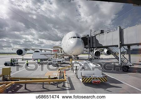 A380 aircraft and tug at stand at airport View Large Photo Image Picture - A380 aircraft and tug at stand at airport. Fotosearch