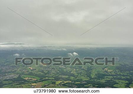 Aerial view of low cloud and distant green fields, England. UK View Large Photo Image Stock Image - Aerial view of low cloud and distant green fields, England. UK. Fotosearch