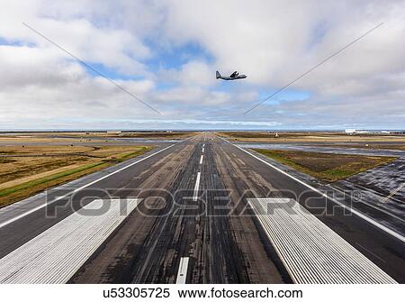 Stock Photography - Aircraft flying off over airport runway, Keflavik, Iceland. Fotosearch