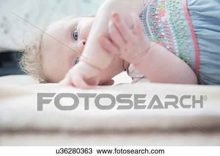 Baby girl lying down View Large Photo Image Stock Image - Baby girl lying down. Fotosearch