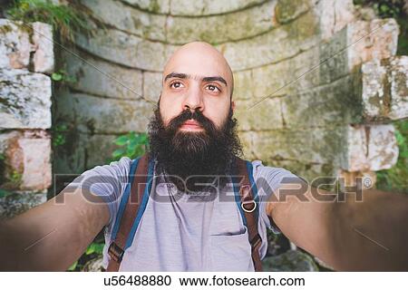 Bearded man posing against old brick wall, Garda, Italy View Large Photo Image Stock Image - Bearded man posing against old brick wall, Garda, Italy. Fotosearch
