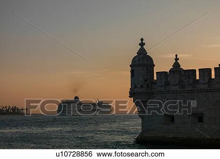 Stock Photograph - Belem Tower and cruise ship on river Tagus at sunset, Lisbon, Portugal. Fotosearch