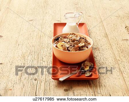 Breakfast bowl of fibre flakes with fruit and milk on wood View Large Photo Image Stock Photography - Breakfast bowl of fibre flakes with fruit and milk on wood. Fotosearch
