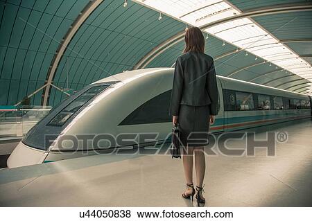Business woman waiting for a train on railway platform, Shanghai, China View Large Photo Image Stock Photo - Business woman waiting for a train on railway platform, Shanghai, China. Fotosearch