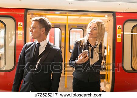 Businessman and businesswoman alighting train, London Underground, UK View Large Photo Image Stock Photo - Businessman and businesswoman alighting train, London Underground, UK. Fotosearch
