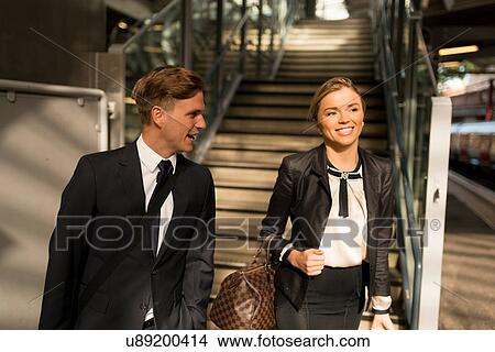 Businessman and businesswoman at bottom of stairs, Underground station, London, UK View Large Photo Image Picture - Businessman and businesswoman at bottom of stairs, Underground station, London, UK. Fotosearch