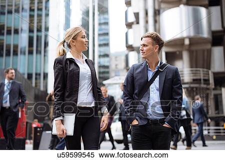 Stock Photography - Businessman and businesswoman in city centre, London, UK. Fotosearch
