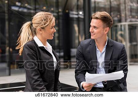 Businessman and businesswoman meeting outside office building, London, UK View Large Photo Image Stock Image - Businessman and businesswoman meeting outside office building, London, UK. Fotosearch