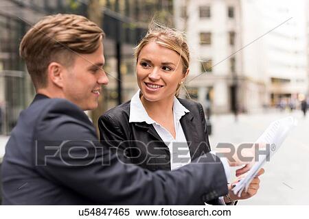 Businessman and businesswoman meeting outside office building, London, UK View Large Photo Image Stock Photography - Businessman and businesswoman meeting outside office building, London, UK. Fotosearch