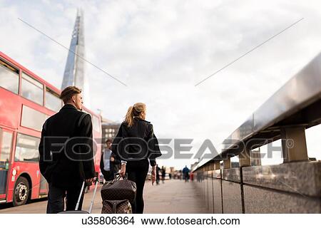 Picture - Businessman and businesswoman on business trip, London, UK. Fotosearch