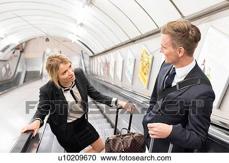 Businessman and businesswoman on escalator, London Underground, UK View Large Photo Image Stock Image - Businessman and businesswoman on escalator, London Underground, UK. Fotosearch